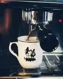 Espresso pouring into a porcelain cup